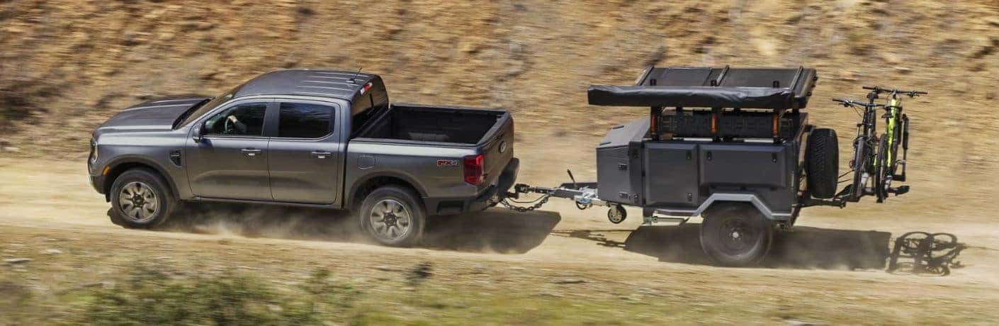2025 Ford Ranger side view on a dirt trail towing a trailer