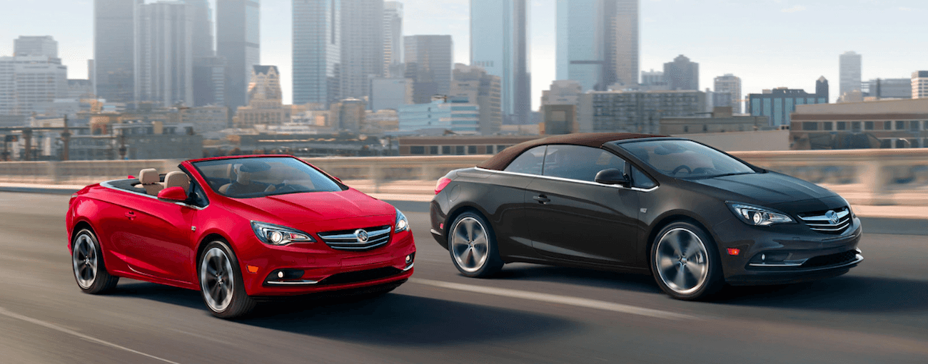 Red and black 2019 Buick Cascadas with city in background