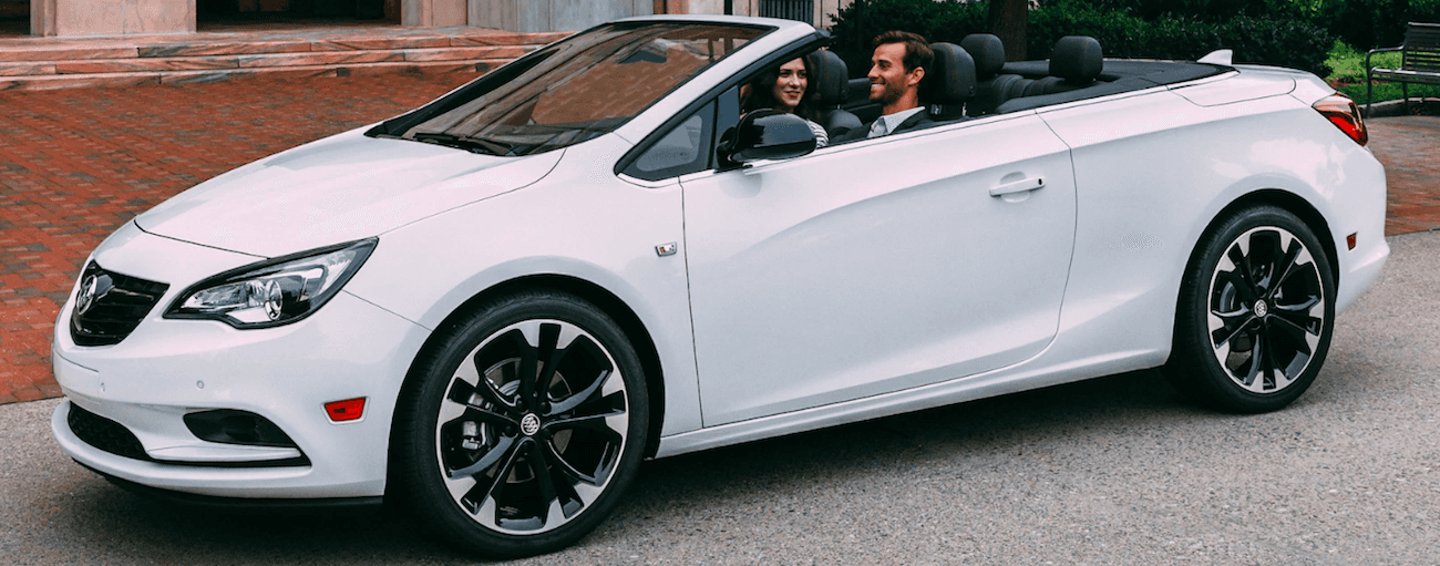 Man driving white 2019 Buick Cascada with woman in passenger seat