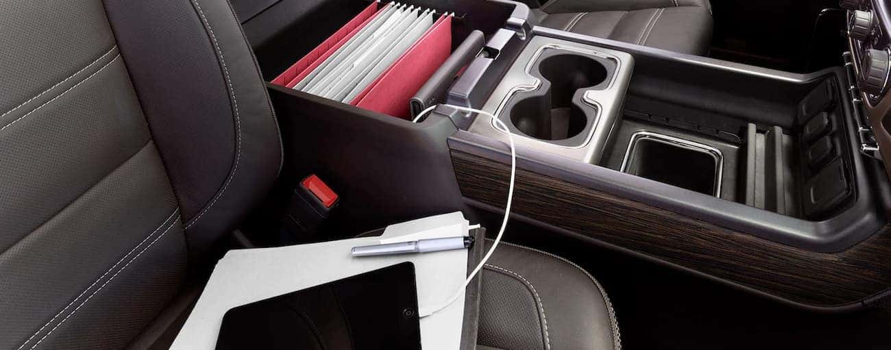 Storage compartment in 2019 GMC Sierra 3500HD center console, holding files, charging ipad