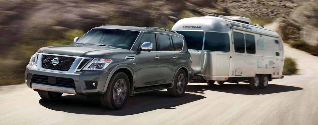 Gray 2019 Nissan Armada towing airstream camper in desert