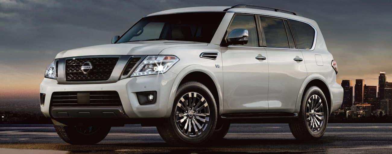 Silver 2019 Nissan Armada at sunset, city skyline in back