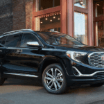 A black 2019 GMC Terrain next to a Roswell GA restaurant