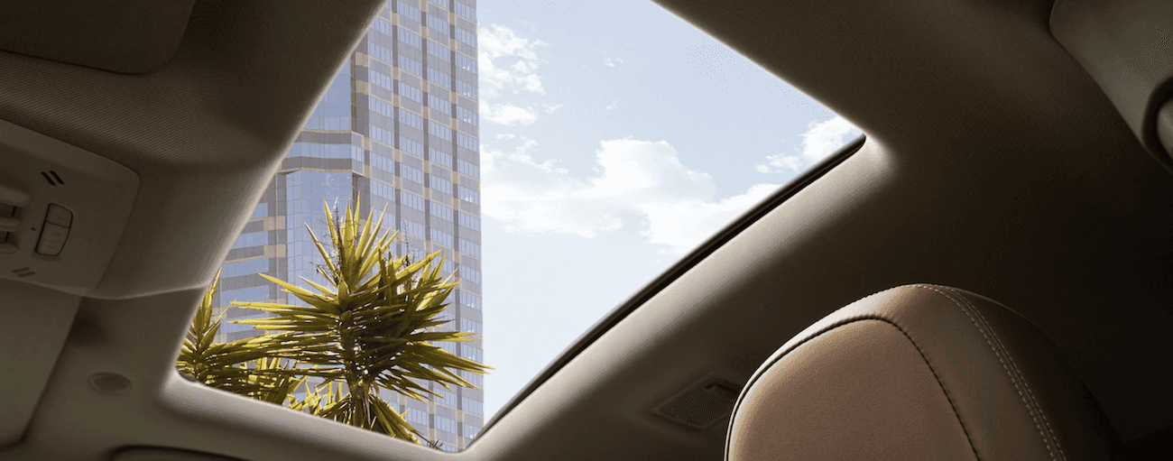 The large sunroom in the 2019 Buick Encore, open on a sunny summer day