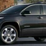 2019 GMC Acadia exterior front fascia and driver side in front of brick building