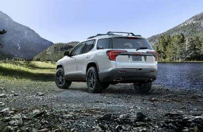 2020 GMC Acadia AT4 exterior back fascia and driver side in valley next to lake