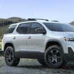 2020 GMC Acadia AT4 exterior front fascia and passenger side in valley between mountains