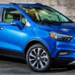 2019 Buick Encore exterior front fascia and passenger side in front of brick building