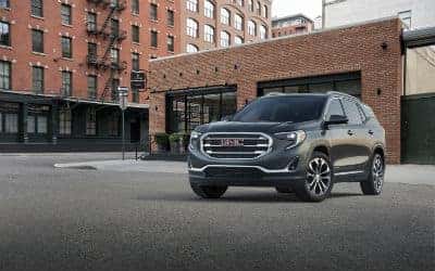2019 GMC Terrain SLT exterior front fascia and driver side in front of apartment building garage