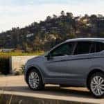 2020 Buick Envision exterior back fascia and driver side in front of hedges