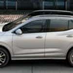 2020 Buick Encore GX exterior driver side profile on tiled road next to glass building