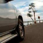 generic truck passenger side close up turning curve on highway