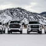 2021 GMC AT4 Lineup of Vehicles in front of snowy mountain
