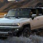 2024 GMC HUMMER EV SUV Exterior Driver Side Front Profile Fording through Water