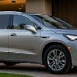 silver buick enclave avenir in front of house