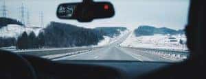 a vehicle driving on a wintery road