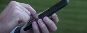 two hands holding a phone side view