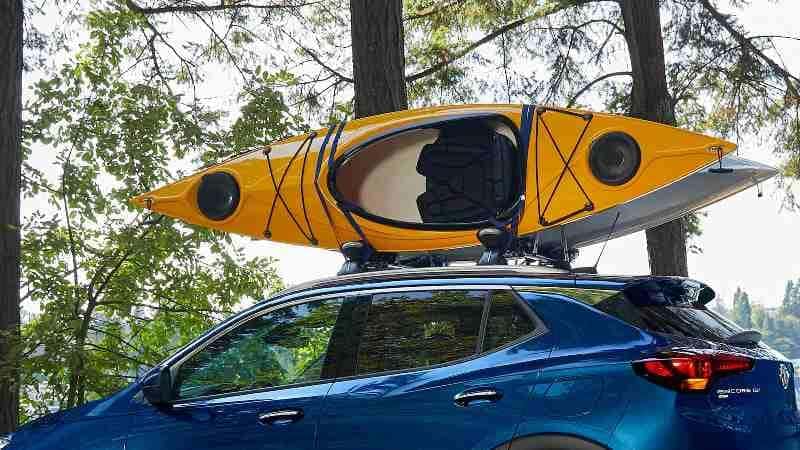 A 2022 Buick Encore GX with available roof rack, which is holding two canoes.