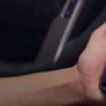 a hand holding a cellphone in a vehicle