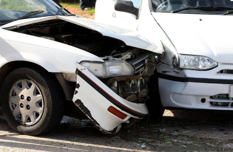 two white cars in a crash close up