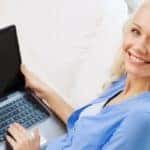 A woman with a laptop in her lap