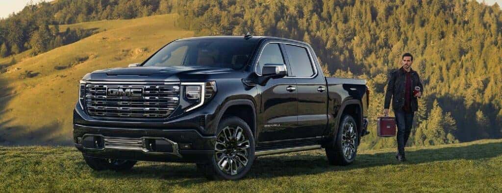 2023 GMC Sierra truck front view with a man