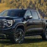 2023 GMC Sierra truck front view with a man