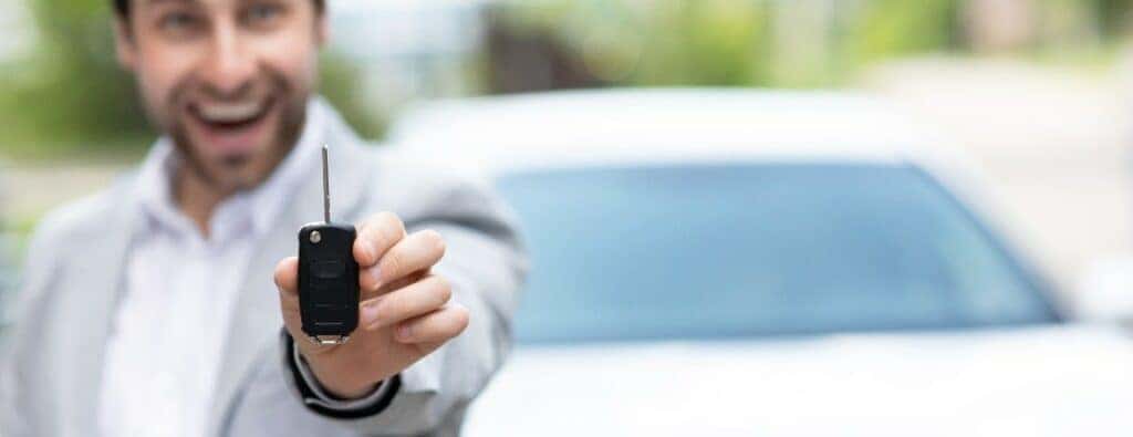 A man holding a car key