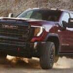 2024 GMC Sierra HD AT4X front view on a dirt road