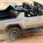 2023 GMC Hummer EV driving in sand