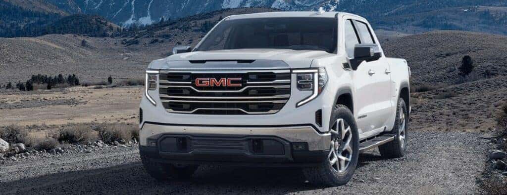 2024 GMC Sierra front view on gravel with white paint