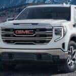 2024 GMC Sierra front view on a road with white paint