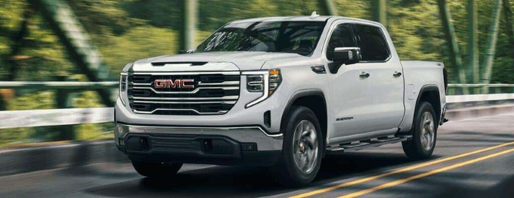 front and side view of a 2024 GMC Sierra truck on a road