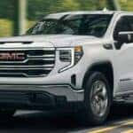front and side view of a 2024 GMC Sierra truck on a road