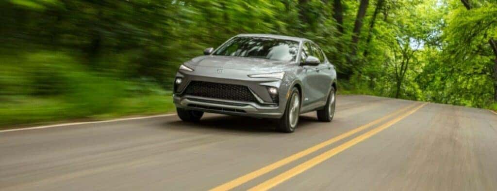 2024 Buick Envista Avenir driving on a forested road