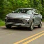 2024 Buick Envista Avenir driving on a forested road