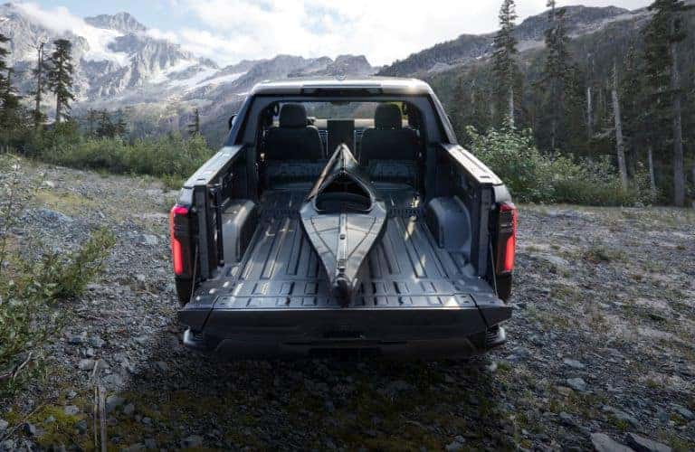 GMC Sierra EV Denali rear view with kayak in bed