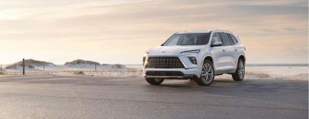 2025 Buick Enclave parked on a beach with white paint
