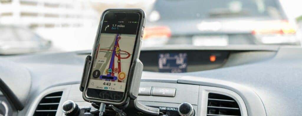 a phone plugged into a car infotainment system