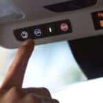 Buick roadside assistance button being pushed inside a car