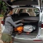 a person using a Buick cargo cover in the rear of their SUV
