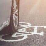 A car tire driving in the bike lane