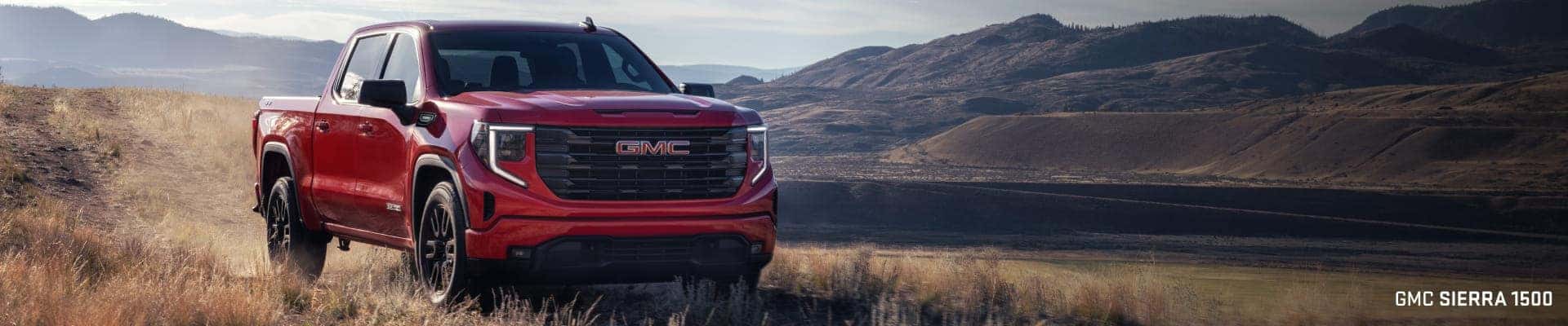 2026 GMC Sierra 1500 truck parked on a grassy hill.