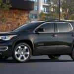 A black 2019 GMC Acadia outside and upscale home