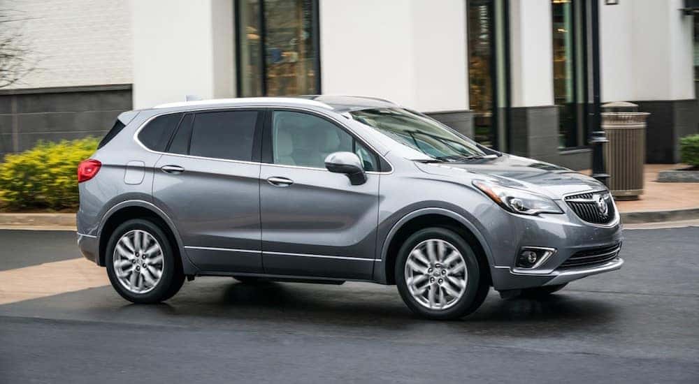 A gray 2019 Buick Envision driving on a city street