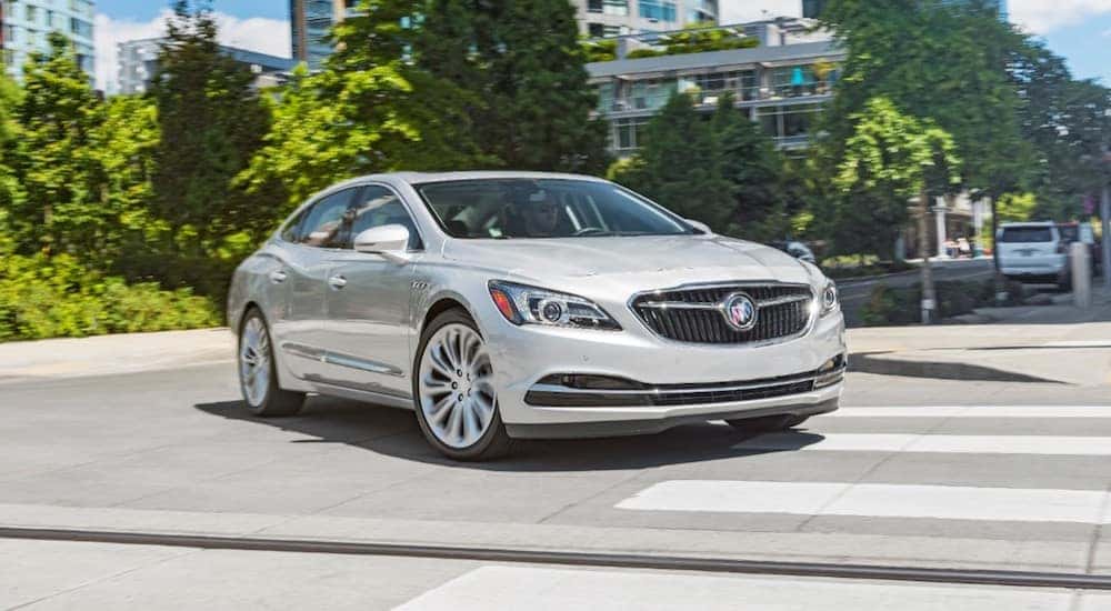 A silver 2019 Buick LaCrosse driving leaving a Buick dealership near me