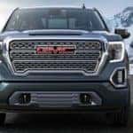 front grille of 2019 GMC Sierra with mountains in background
