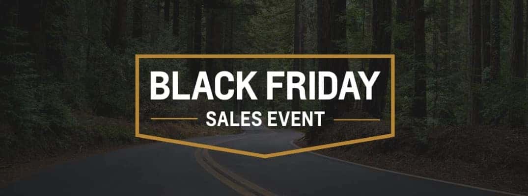 Black Friday Sales Event logo against an image with woods and a road