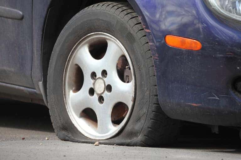 Close-up of a flat tire on a sedan