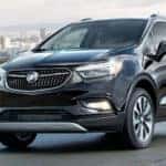 2020 Buick Encore exterior front fascia driver side on road with blurred grass and city